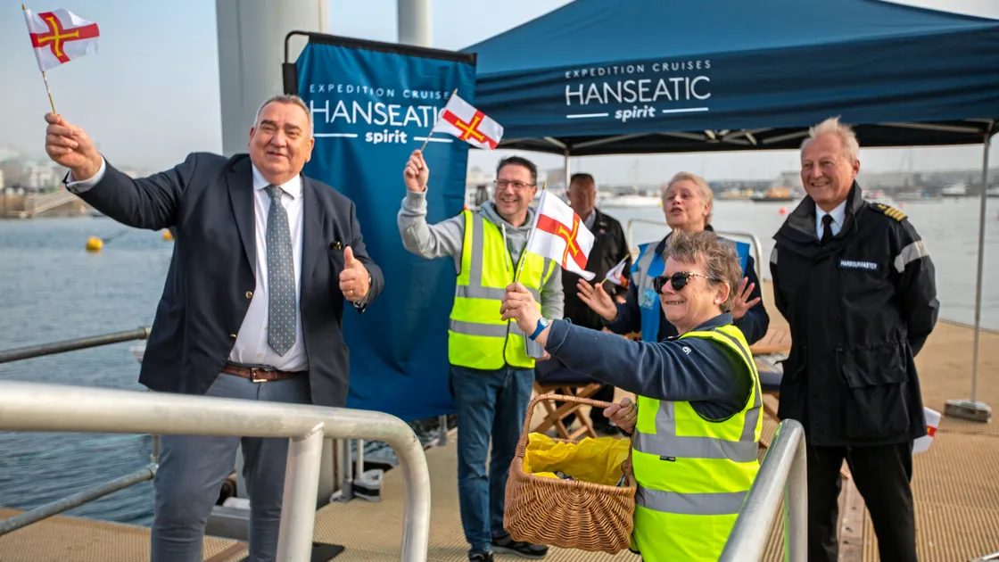 Welcoming passengers from the Hanseatic Spirit, left to right, Economic Development tourism lead Deputy Simon Vermeulen, cruise operations deputy manager Mark Renouf, cruise pier manager Isabel De Menezes (blue jacket), deputy team leader Marie Jones and harbourmaster David Barker. (Picture by Luke Le Prevost, 30723983)