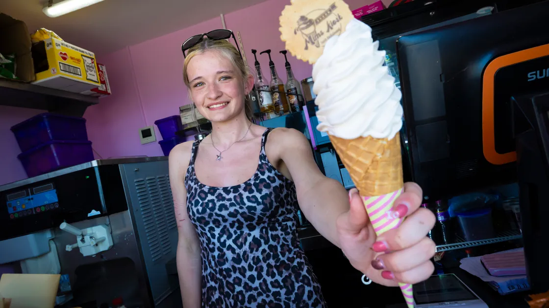 Lily Sarre offers an ice cream at Mim’s Kiosk at Cobo.