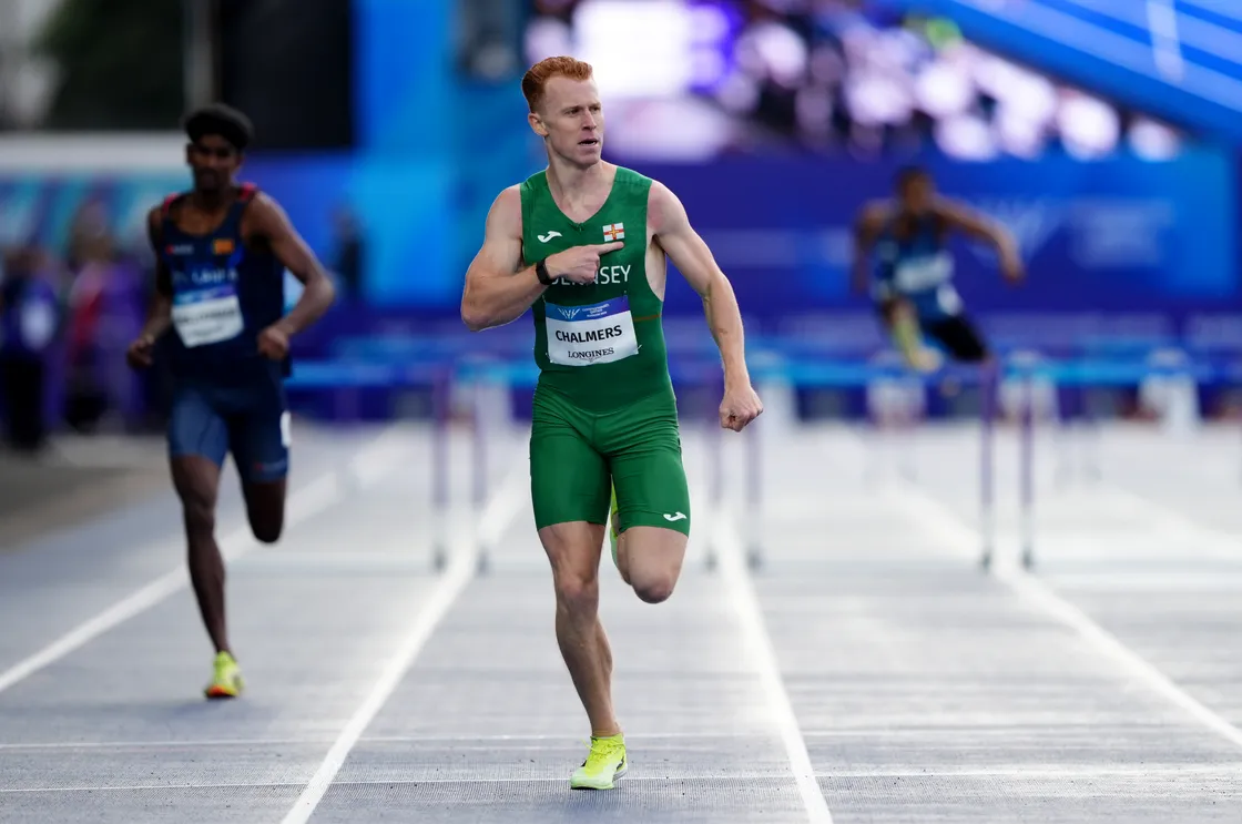 Chalmers pointed to the Guernsey badge as he crossed the line in Glasgow.