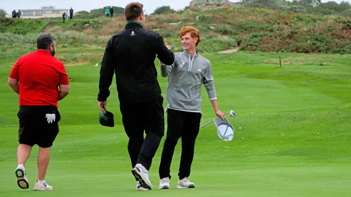 Comeback complete: Jayden Tucknott is all smiles as he is congratulated by his caddy Harry Bushby after beating Josh Ozard in the anchor match of yesterday's Men's Inter-Insular singles to seal an amazing 11-9 comeback victory for Guernsey, who had been whitewashed in the opening foursomes.
Picture by Gareth Le Prevost, 08-09-24 (33579848)