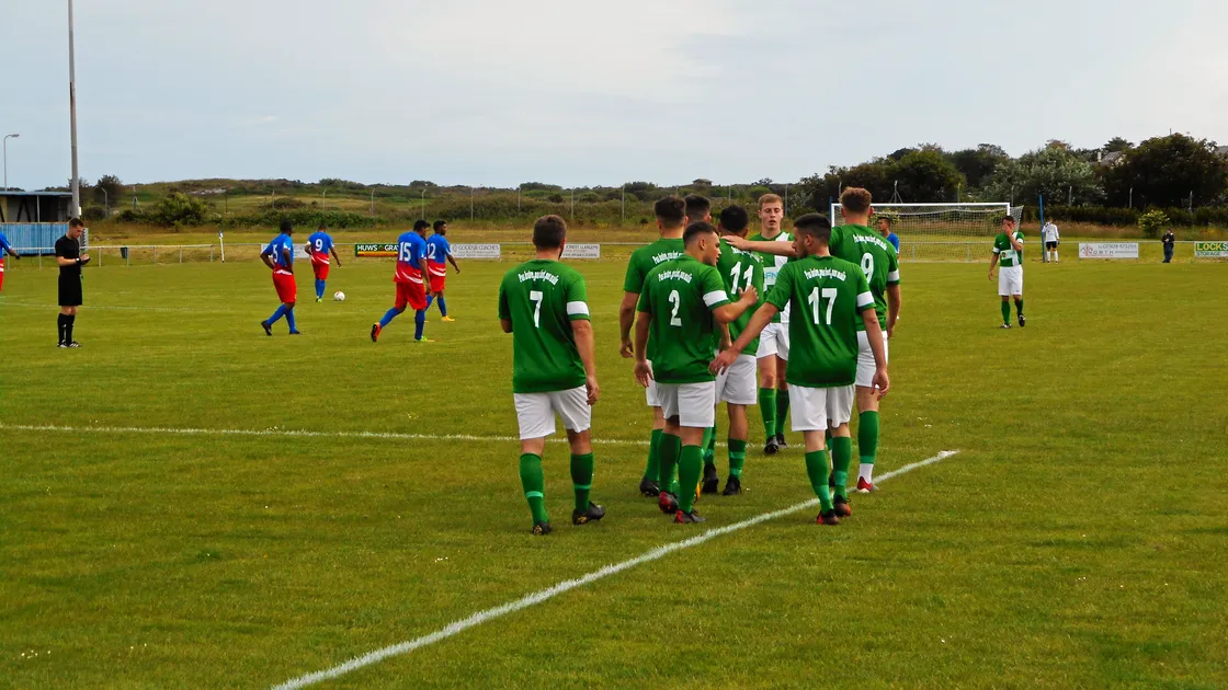 In the goals: Guernsey, back to wearing green shirts, celebrate one of their nine goals against St Helena in Ynys Mon. (Picture by Sports News Agency, 24988731)