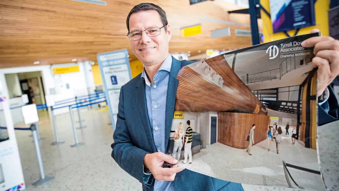 Brian Tyrrell, a director of project architect Tyrrell Dowinton, with a computer-generated artist’s impression of the new-look departures. 	          (Picture by Peter Frankland, 22872209)