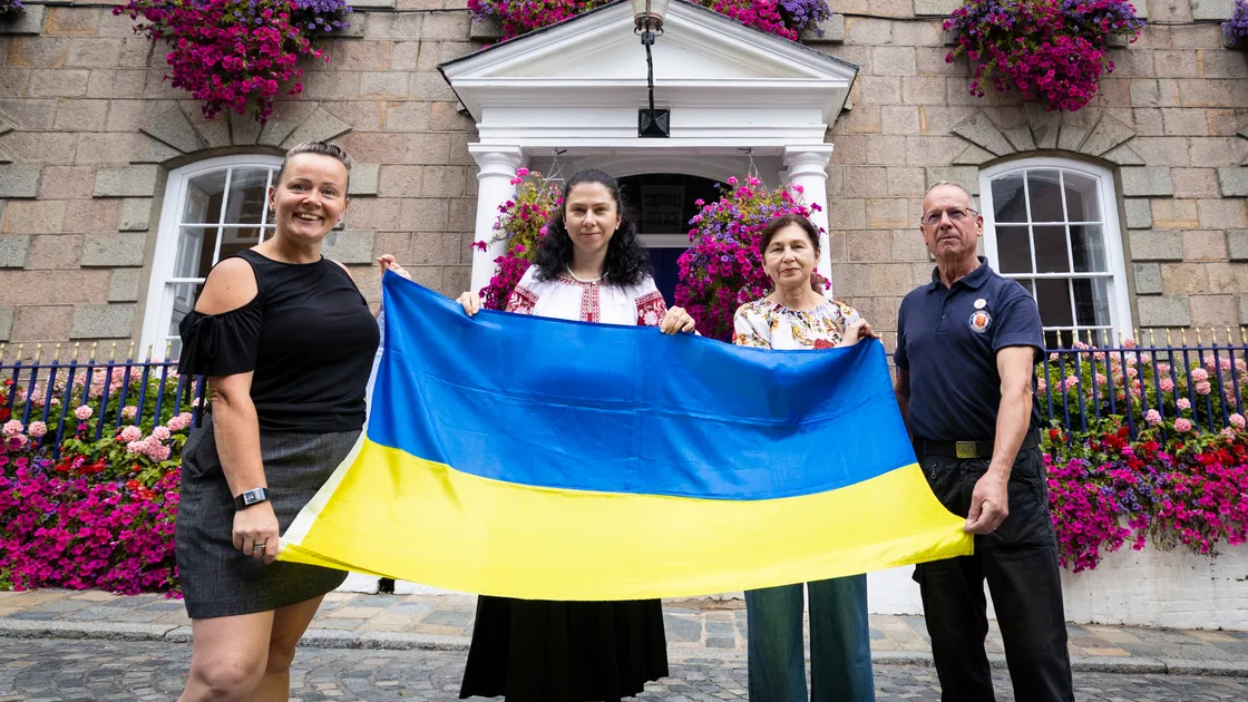 Left to right: St Peter Port douzenier Evita Bormane, Ukrainian national Anna Konstantynova, her mother Alla Vasyleha and St Peter Port douzenier and grounds team manager Chris Inder with the Ukrainian flag that has been raised at St Peter Port Constables’ Office.