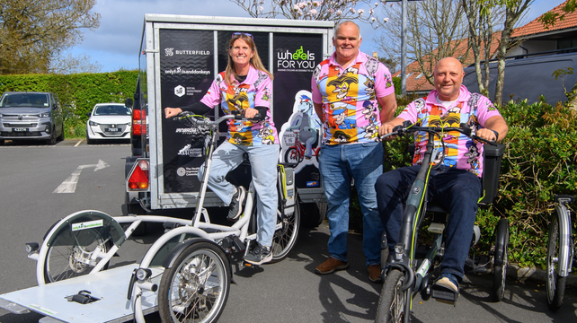 Fundraising cyclists donate new bike trailer to charity