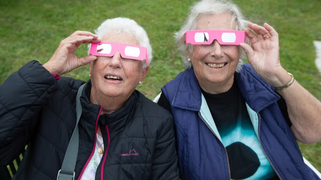 Patsy Self, left, and Mary Thompson were two of those using special eclipse viewing glasses as conditions did not allow La Societe’s telescopes to be used. (29640983)