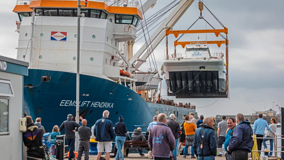 Dozens of people watched on as the San Pawl was painstakingly winched off the boat.