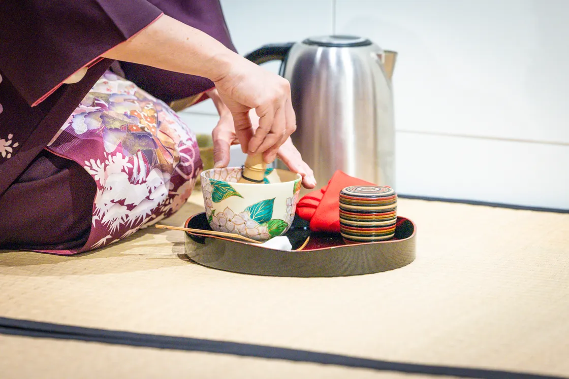 The matcha tea is stirred with a chasen