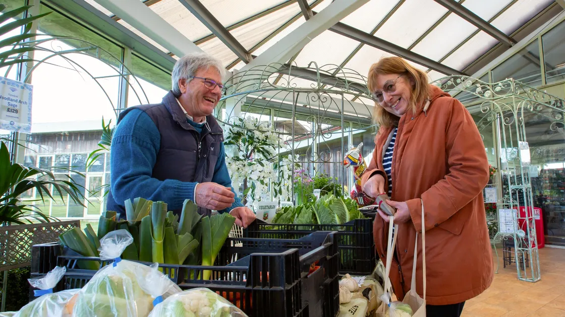 Chris Workman serves Caroline McManus some of his produce at the Castel Farmers' Market. (Picture by Karl Dorfner, 33086592)