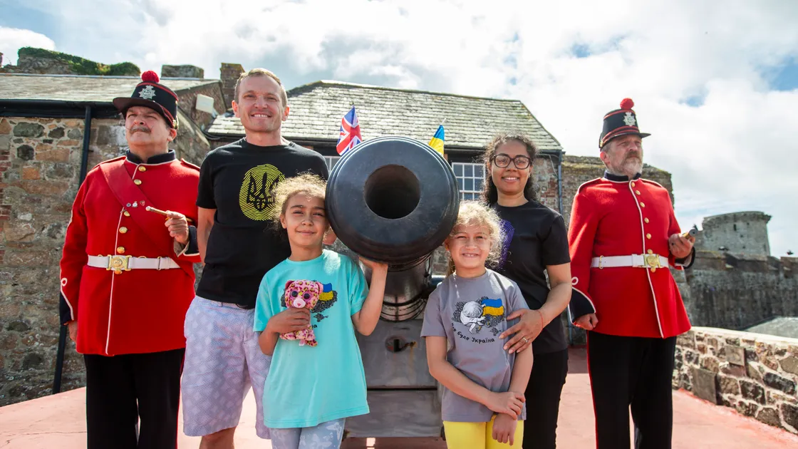 The Ameri family from Ukraine at Castle Cornet. Left to right, Shaun Marsh, Ivor, Gabriella, 9, Daniella, 8, Biola Ameri and Stuart Falla. (Picture by Luke Le Prevost, 32372020)
