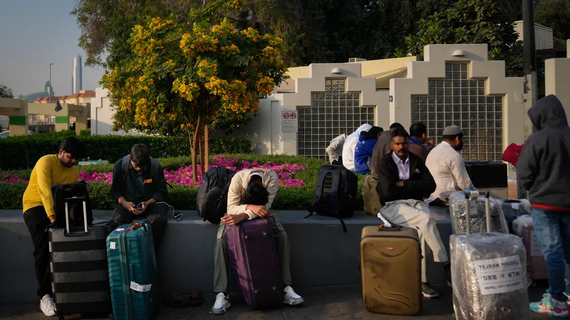 Passengers stranded by the closure of Dubai International Airport await for assistance in the airport parking lot in Dubai, United Arab Emirates, Sunday, March 1, 2026. (AP Photo/Altaf Qadri). (34651166)