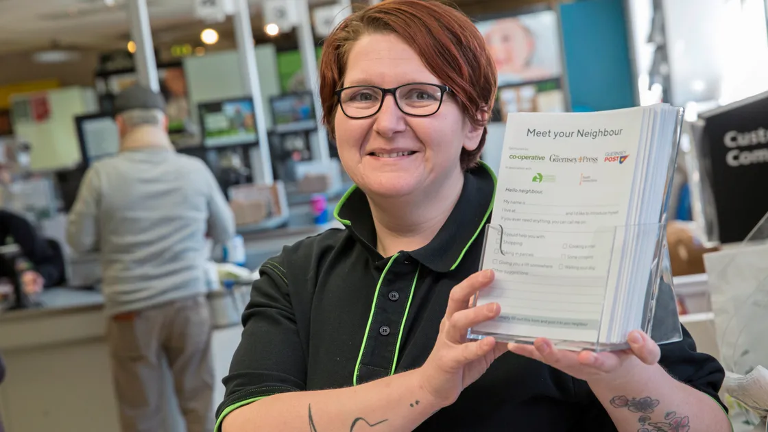 Co-op bakery assistant Sam Bull with the Meet Your Neighbour forms, which are being delivered by Guernsey Post and which are available from Co-op shops. (Picture by Peter Frankland, 23980270)