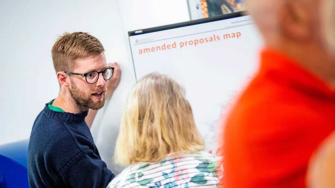 Development & Planning Authority vice-president Deputy Andy Taylor explaining its proposed amendments to the Island Development Plan at Saturday’s drop-in. (Picture by Peter Frankland, 33376592)