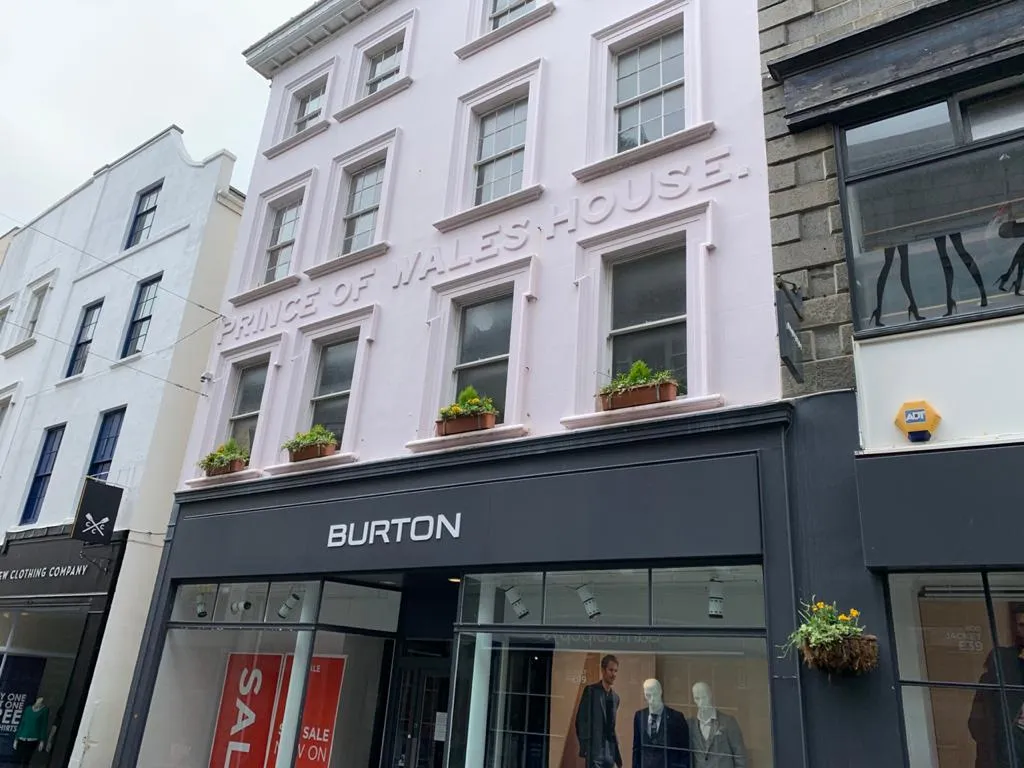 The facade of Burton, as it was, showing the Prince of Wales House name. 		