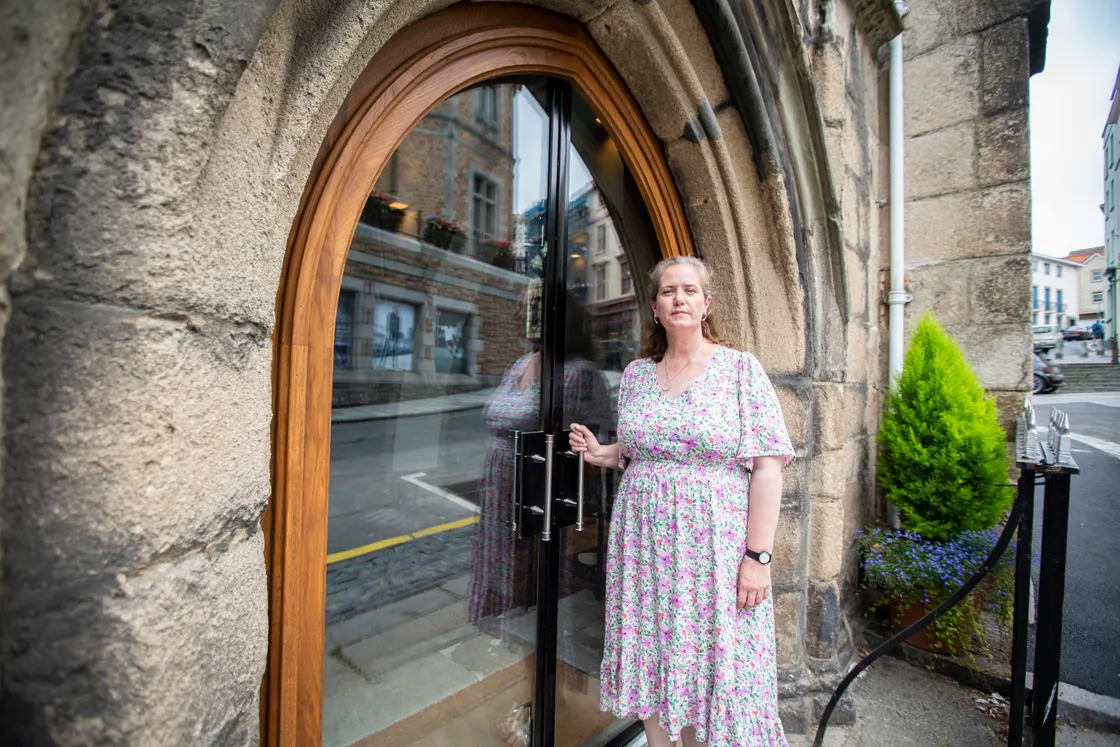 Ruth Abernethy alongside one of the new glass doors. (31063825)