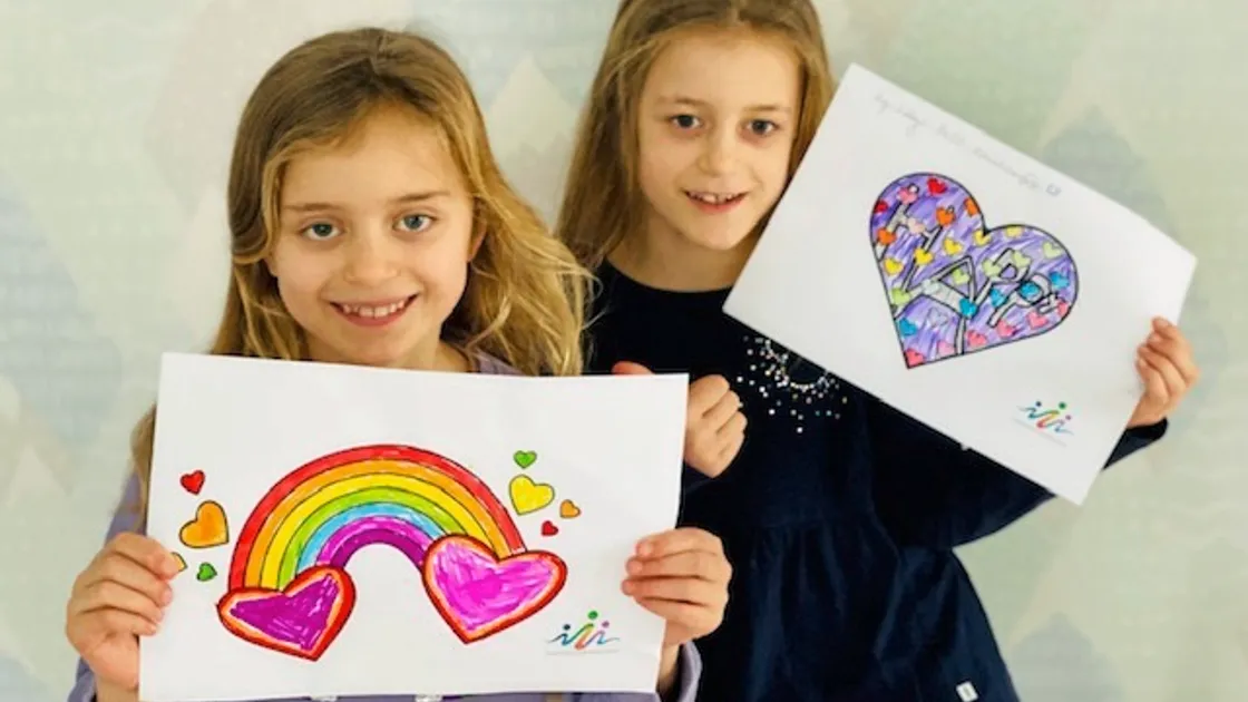 Seven-year-old twins Lottie, left, and Tilly Rainbow with the hearts they will put up in their window. (Picture supplied by the founder of Guernsey With Kids, Antonia Rainbow)