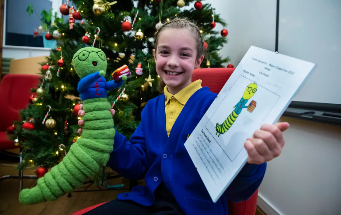 Lily Hurrell, 9, with her winning design, Dissy The Dyslexic Bookworm. (29006125)