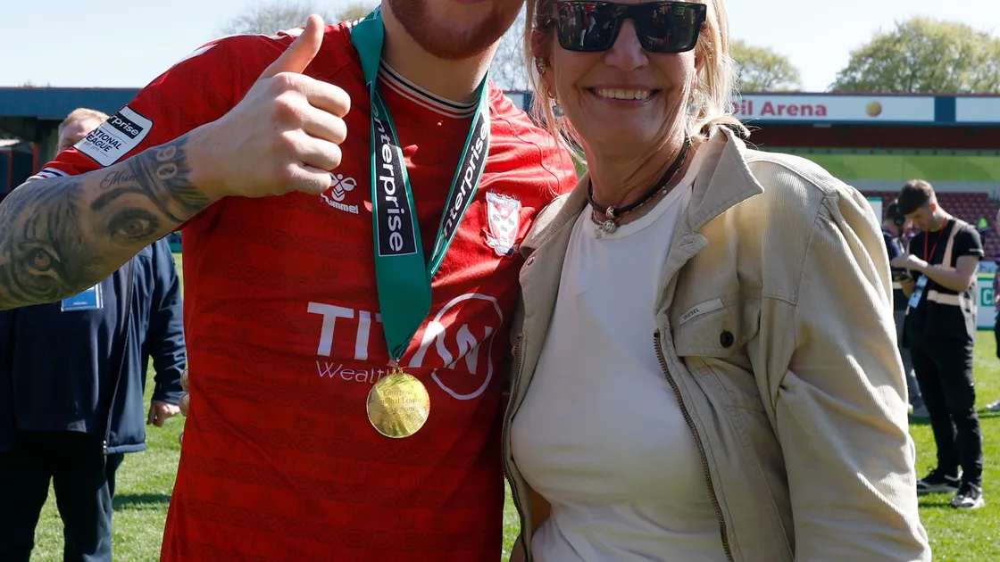 York City’s Josh Stones, left, with co-owner Julie-Anne Uggla, the woman behind the Blonde Hedgehog in Alderney, celebrate on the pitch after the Enterprise National League match at the Crown Oil Arena in Rochdale on Saturday.  (Picture: Cody Froggatt/PA Wire)