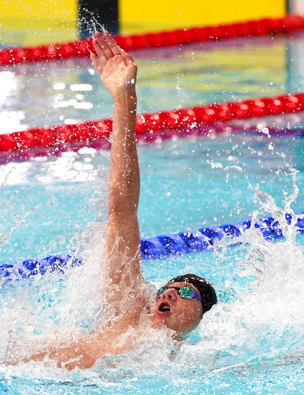Zachary Maiden swimming in the men’s 50m backstroke heats. The 15-yearold swam personal bests in all five of his events in Glasgow.