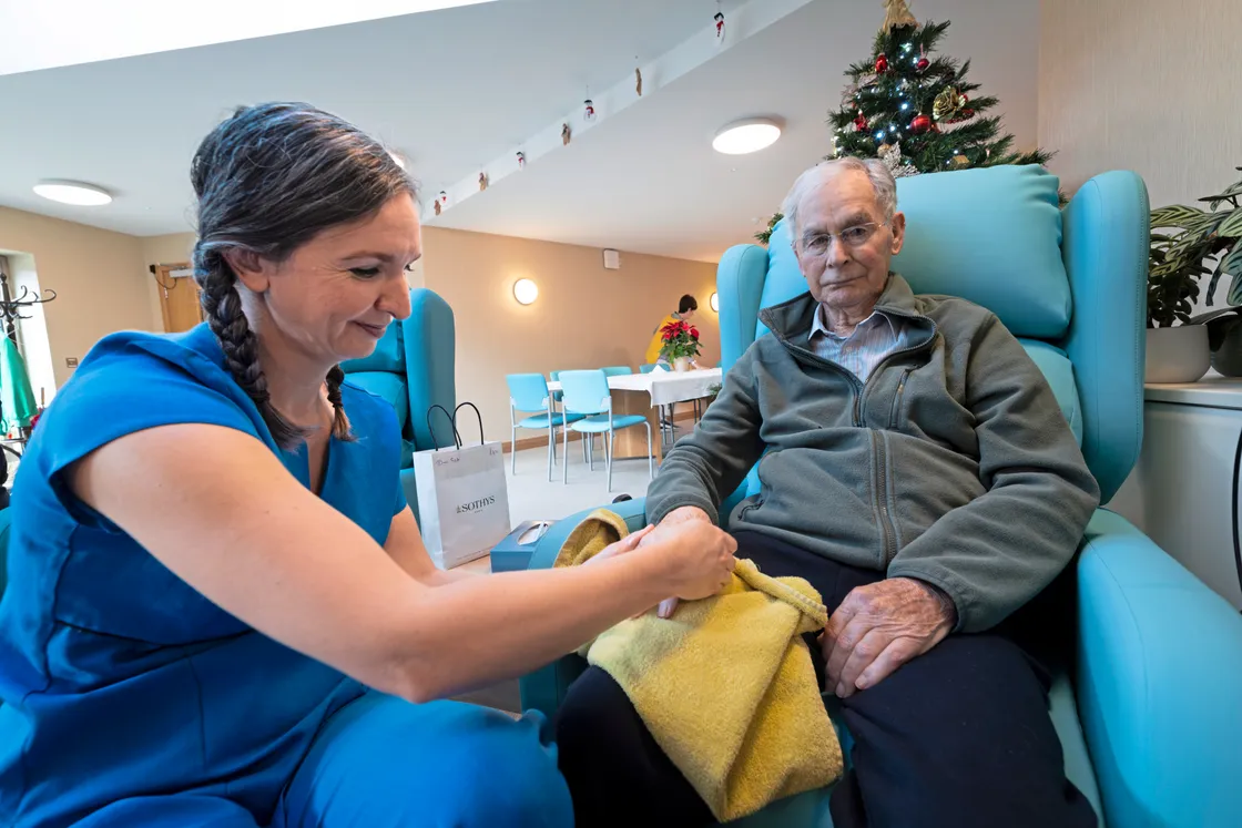 Luisa’s Beauty Salon owner Luisa Chiappa-Sarre, who volunteers at the centre, gives John Ozanne a hand massage