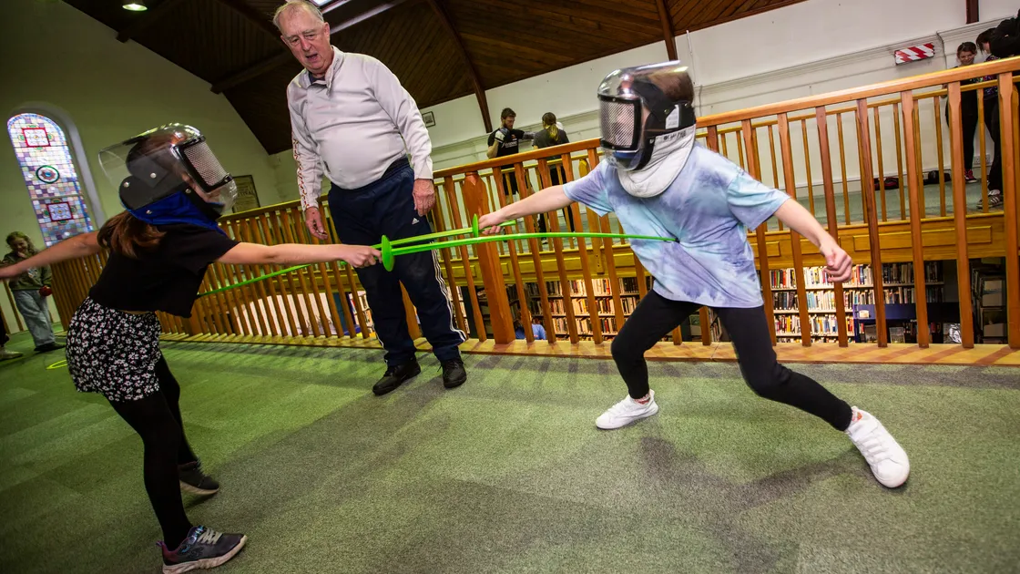 Juliette Norman and Emiko Lucas trying out fencing at last year’s Sport in the Library event at the Guille-Alles