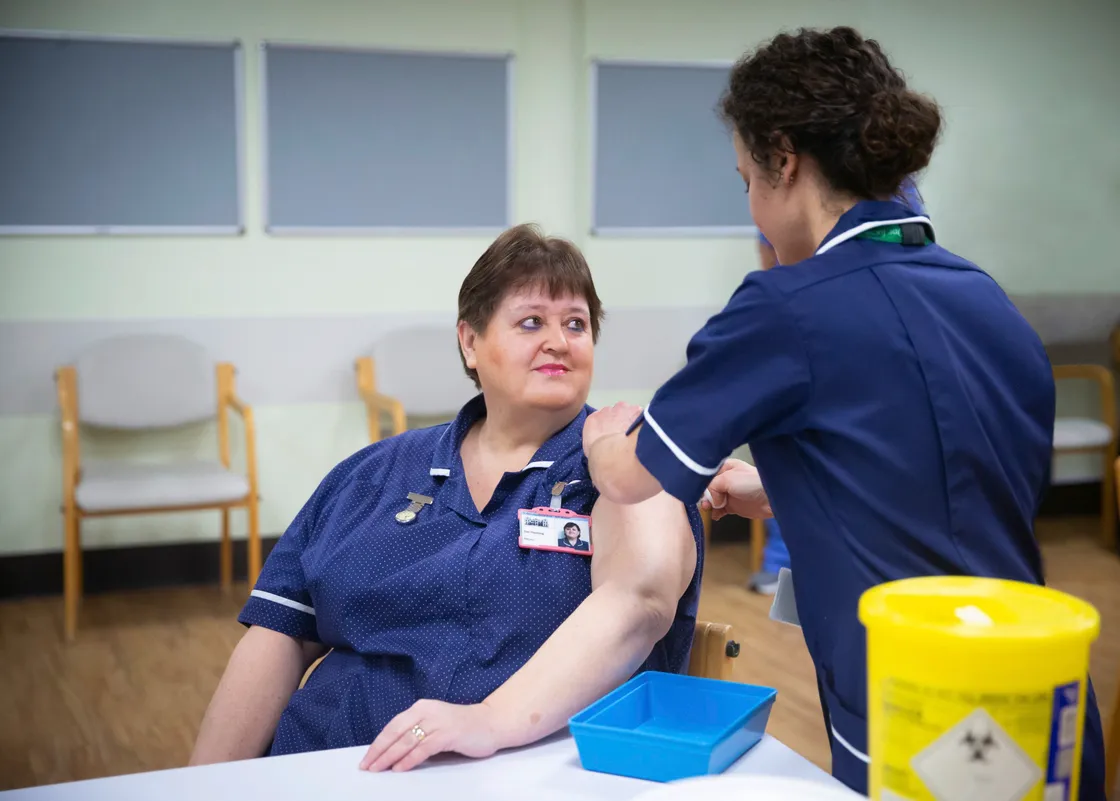 The first person to receive the first dose of the Pfizer/BioNTech vaccine was Dr Sue Fleming, Matron of St John's residential home. Jo Rocha, Health Protection Nurse administers the vaccine. (Picture by Peter Frnakland, 29047976)