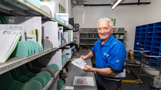 Red letter day for postie Sammy as he turns 80