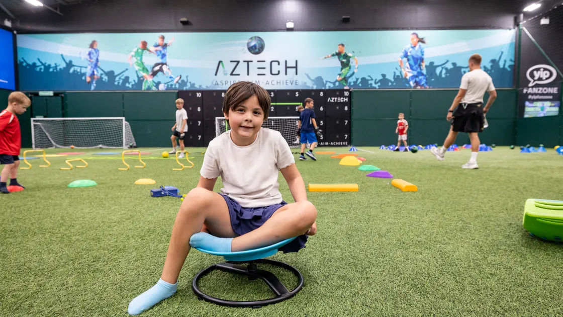 Aztech offered its space throughout the school holidays to be used for free by Autism & Me. Pixie Merrien, 8, is pictured. Children were able to play and enjoy activities on offer while parents could watch. Below, Billy Lewis, 7, Ethan Mullaly, 8, and Edward Greenway, 6, playing football with Aztech coaches Charlton Gauvain and Frazer Maginnis. 							 (Pictures by Sophie Rabey, 34913115)