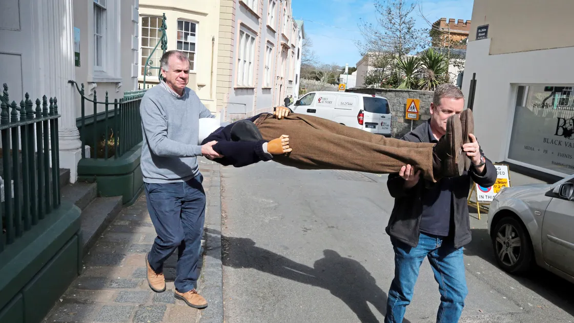 Costumes and props from the Guernsey Literary and Potato Peel Pie Society film are currently being exhibited at Candie Museum. Above, a mannequin being moved in St John’s Street.
Far left, hand-written letters used in the film. Near left, Guernsey’s head of Heritage Services, Jason Monaghan. 
(Pictures by Steve Sarre, 21037652/08)