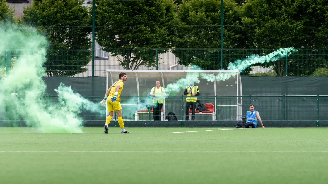 Jersey goalkeeper Euan Van der Vliet clears a flare thrown on the pitch during the Muratti Vase final at Springfield last month.