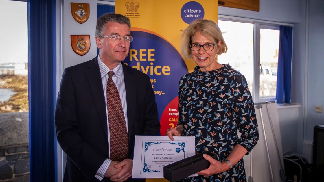 Bailiff Richard McMahon, patron for Citizens Advice, presented Clare Burton with her award for 25 years' of service with the charity. (Picture by Sophie Rabey, 29569921)