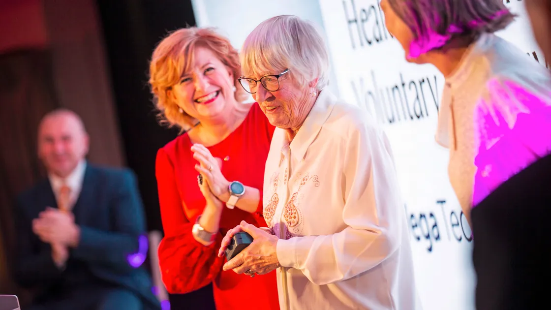 Helen Sarchet from Health Connections Voluntary Transport Service, its longest serving driver, receiving the Bailiwick Community Hero of the Year award at the Guernsey Press Pride of Guernsey Awards 2024.