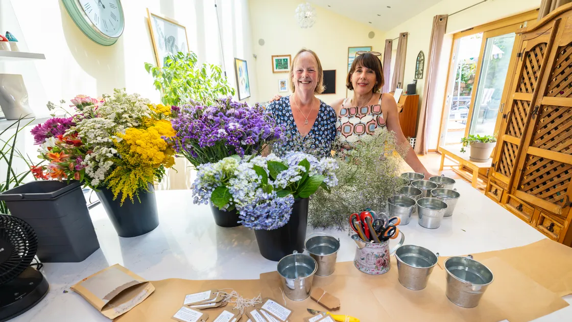 Connect MND Guernsey chairwoman Abbie Duncan, right, and committee member Trish De Carteret with the flower bouquets that the group will be handing out tomorrow at the Liberation Monument.