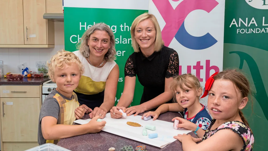 Lloyds Bank Foundation for the Channel Islands executive director Jo Le Poidevin, left, and the Youth Commission’s service manager Charlie Cox with children. 										                   (Picture by Chris George)