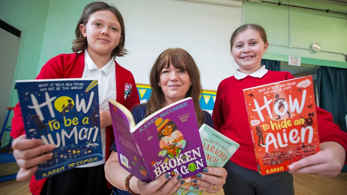 Children’s author Karen McCombie met two fans of her How To series of books in Vale Primary School year 6 pupils Tegan Tracey, left, and Anna Douglas when she visited as part of the Guille-Alles Library’s annual Book Week. (Picture by Peter Frankland, 33010538)
