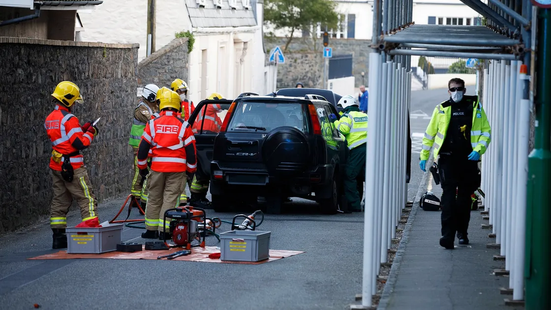 Police and firefighters work protective masks while dealing with a crash that occurred at the Doyle Road/Grange junction on Tuesday evening. (Picture by Tom Videlo)