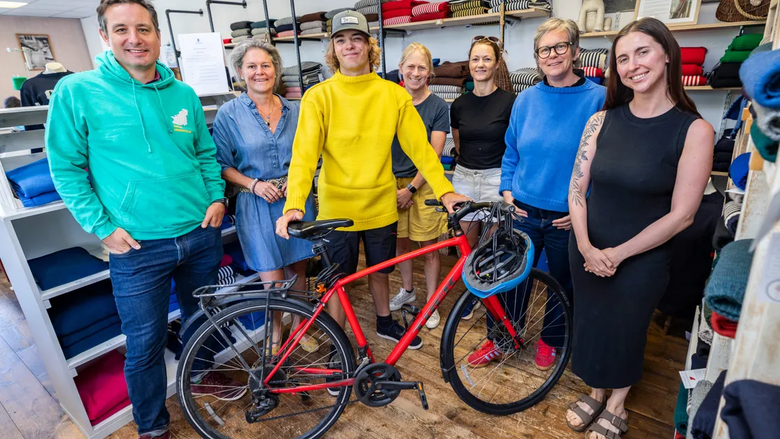 The Health Improvement Commission, with support from the Better Journeys Project, has re-launched a campaign called the Yellow Guernsey Award. Just in time for the next Tour de France, a special yellow Guernsey has been created to be awarded to chosen winning role models in our local community. Sixth Form student Monty Desforges was awarded the first Yellow Guernsey of 2026 for his work heading up the school’s Active Travel Group. Left to right, Director of the Better Journeys Project Rollo de Sausmarez, Tom Dorey’s mother Laurence Dorey, Monty Desforges, HIC Be Active Lead Alex Costen, HIC Active Travel Officer Amy Woollaston, owner of Le Tricoteur Rachael Laine and Monty’s teacher Becky Fawcett. 											 (Picture by Sophie Rabey, 34824166)