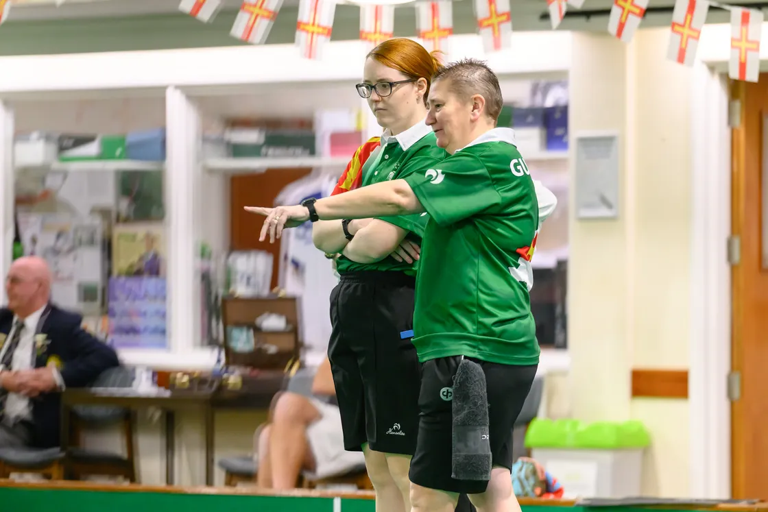 Ali Merrien points something out to her ladies’ triples teammate Catherine Bonsall