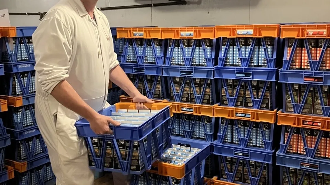 Dairy hand Kieran Queripel with some of the milk crates. (32129182)