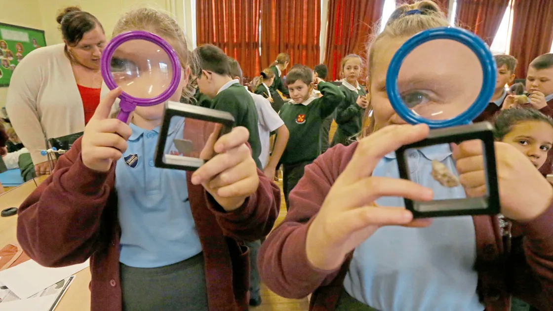 Sophie Robins, left, and Mia Dorey, both 10, were among the pupils from La Mare de Carteret Primary to be taken to Amherst Primary to examine in detail rocks brought back from NASA moon landings.(Picture by Steve Sarre, 20391868)