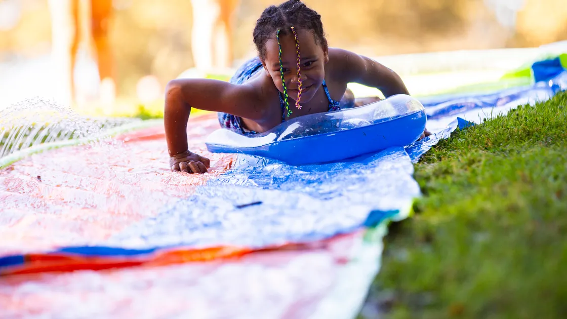 Picture by Sophie Rabey.  02-09-23.  Family Fun Day at Cambridge Park from 12-6pm.
Mia Baker (aged 7) enjoying the water slide. (32487913)