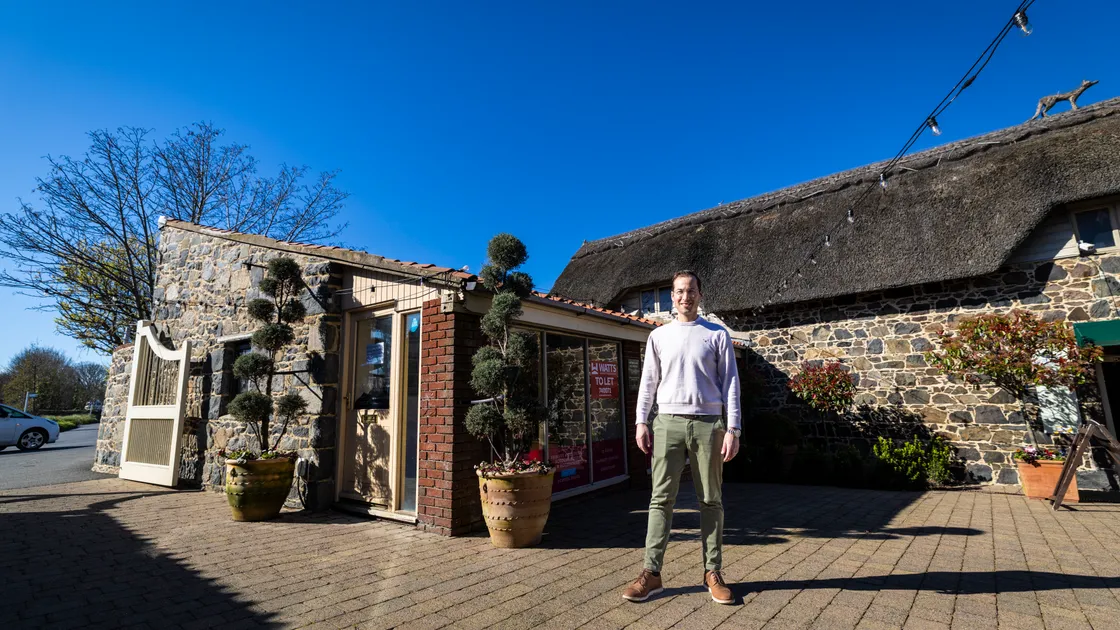 Hilton Ruch, the general manager of Oatlands, pictured at the site where the new Les Bourgs Hospice shop will be located, after the charity was given permission. Above right, the Guernsey Press broke the news of the Oatlands dispute last December.		 		 (Main picture by Peter Frankland, 34675450)
