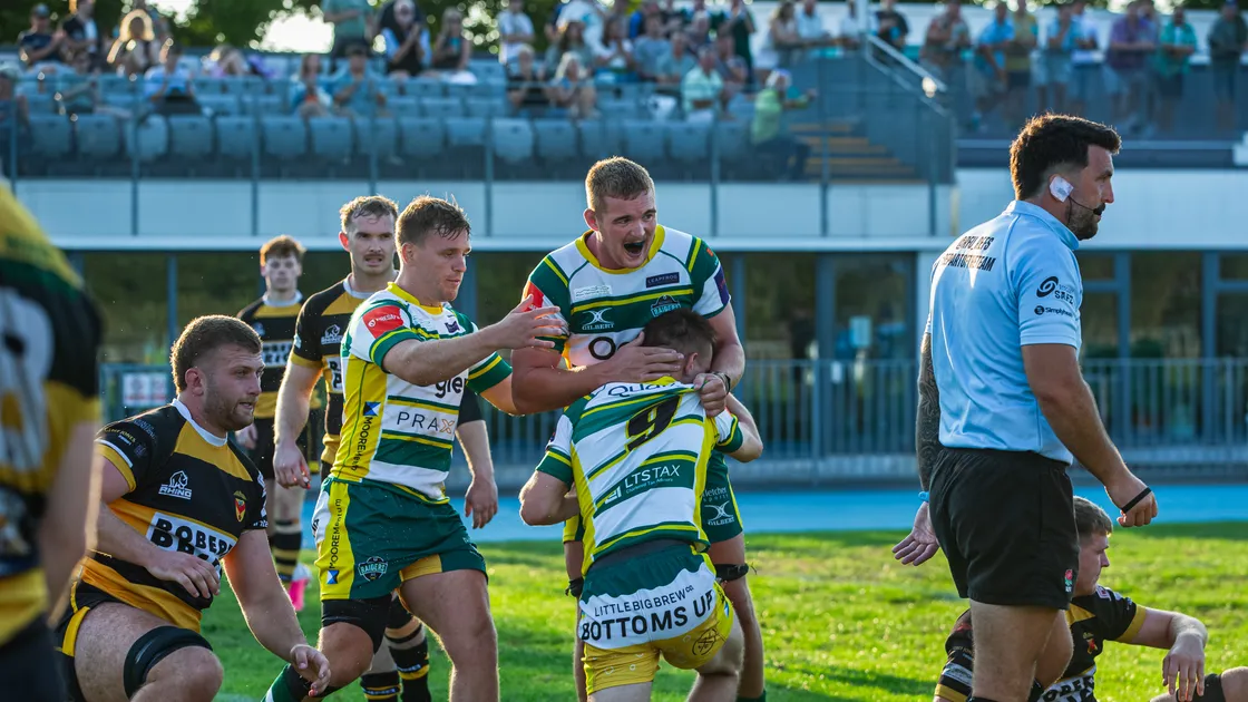 Charlie Simmonds is congratulated on his try by his Raiders teammates.