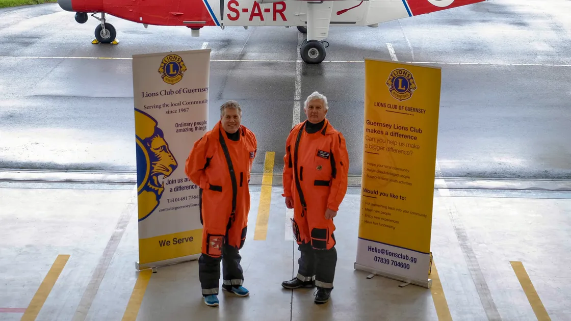 Operational pilot Mark Seabrook, left, and accountable manager John Fitzgerald wearing their new survival suits donated by the Lions Clubs of Jersey and Guernsey. (Picture by Jason Friend, 33870960)
