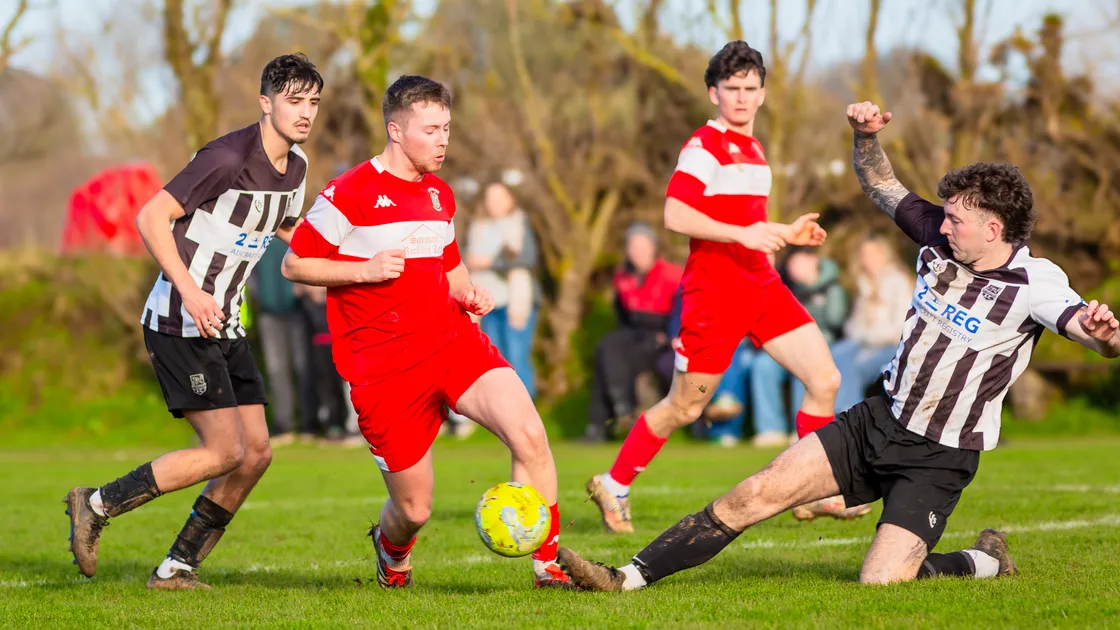 St Martin’s defender Ben Solway tackles fellow goal-scorer and GFC teammate Simon Arnold on Saturday at St Peter’s