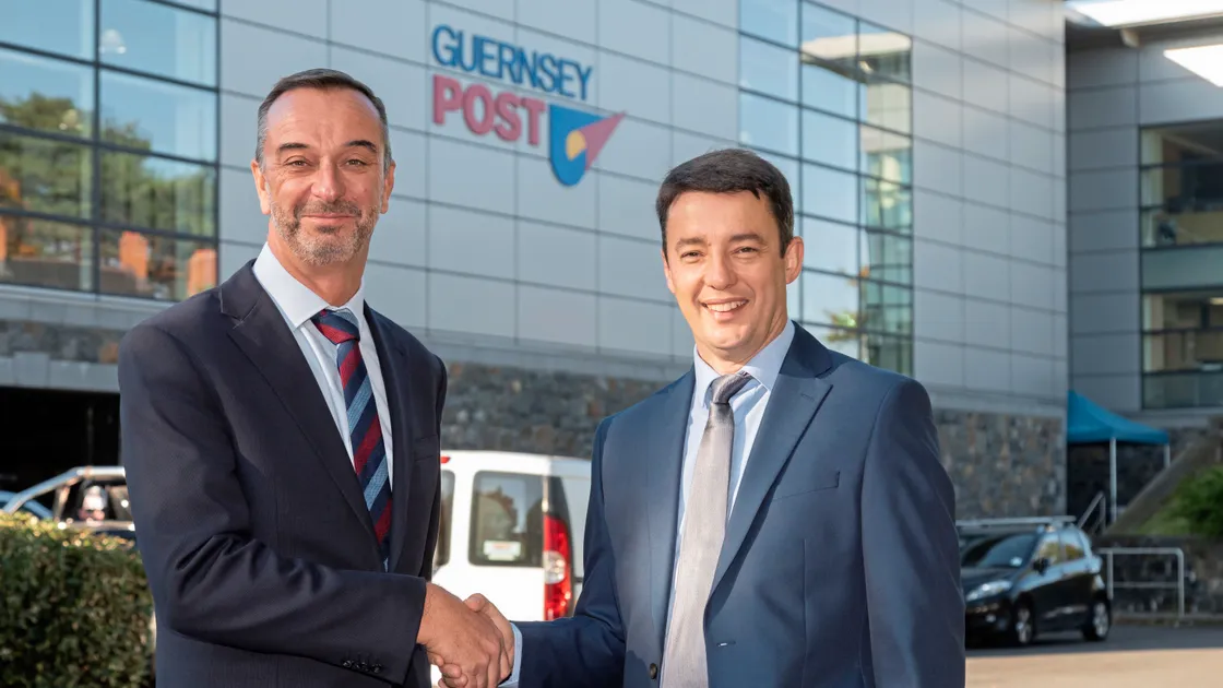 Shaking on the deal to put a solar array on the roof of Guernsey Post headquarters at Envoy House are Guernsey Electricity chief executive Alan Bates, left, and his counterpart Boley Smillie of Guernsey Post. (Picture by Chris George Photography)