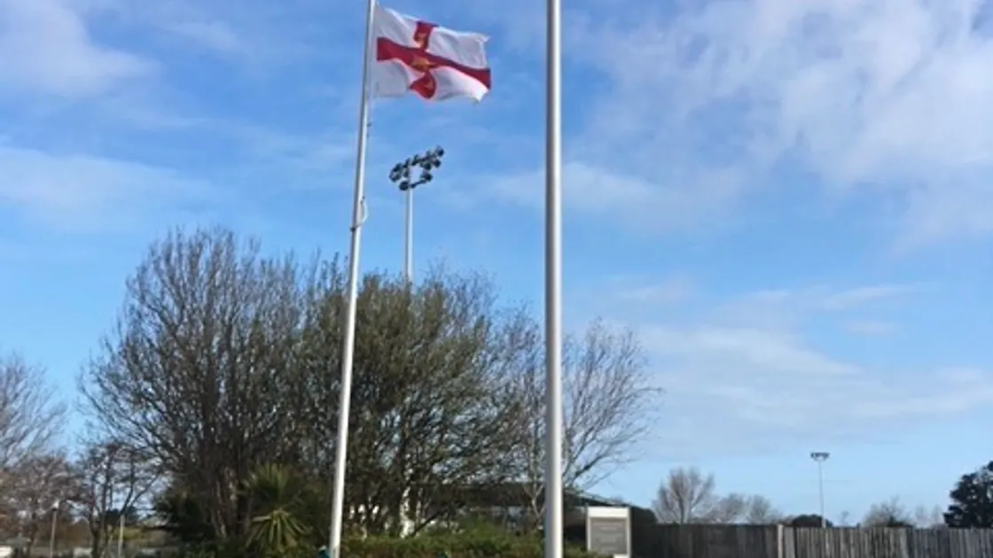 Spike Jinks, 12, flying his prized Guernsey Flag at Footes Lane on Saturday as he and his sister Hattie, 14, do annually on their birthdays before the location is embroidered onto the flag each year. Image by Chris Jinks.  (29389017)