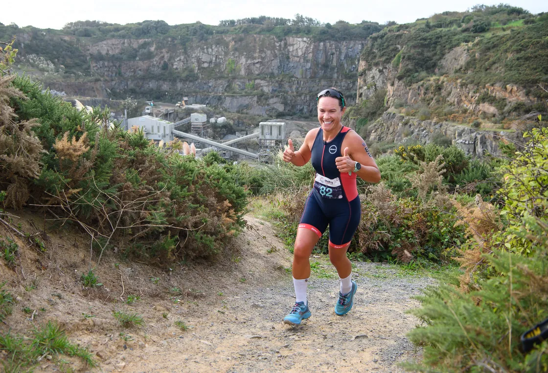 Top three women’s Sprint finisher Katy Hodgetts cracks a smile during the nature trail section.