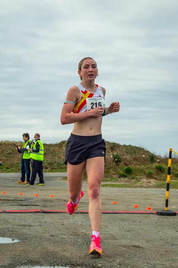 Women's race winner Eloise Scholes matches her 5km personal best as she crosses the finish line.