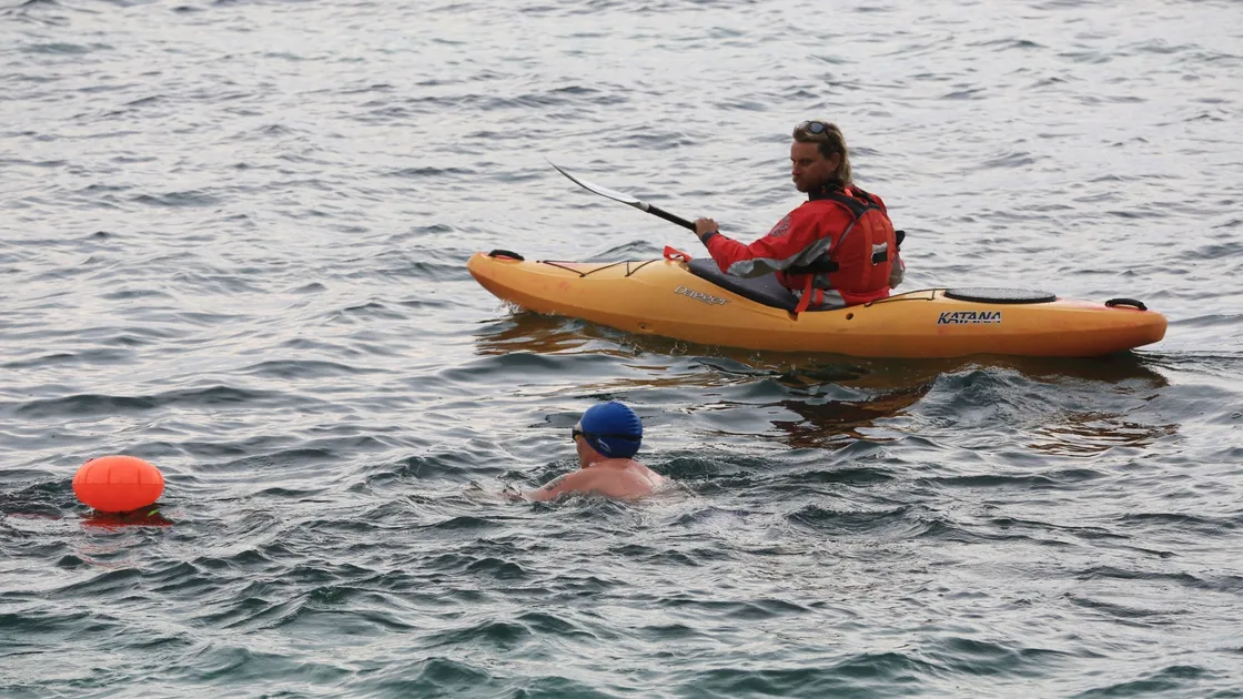 Novice sea swimmer Guy Hardill on his charity swim from the bathing pools and back. Pictured with him in the safety kayak is Phil Le Poidevin from Go Guernsey. (Pictures by Adrian Miller, 28331733)