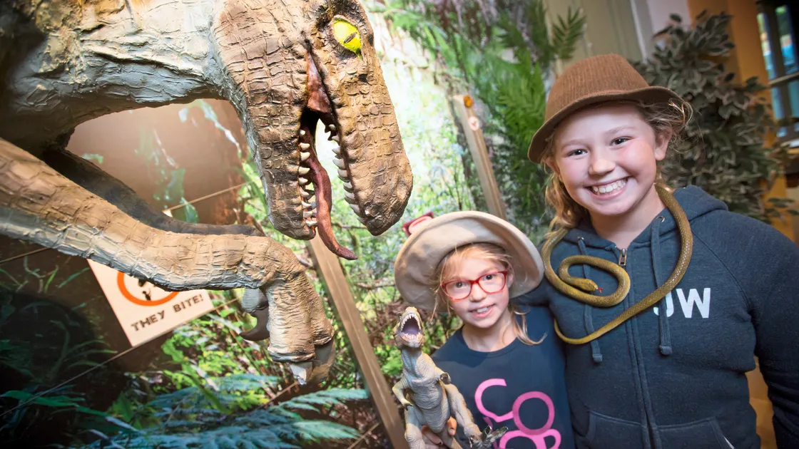 Olivia Tucker, 7, left, and Ella Tucker, at Dino Days at Candie Museum, which runs this October half term. Below, Tayen Littlewood, 6, with dinosaur claw gloves.                               (Pictures by Peter Frankland, 22963884/72)